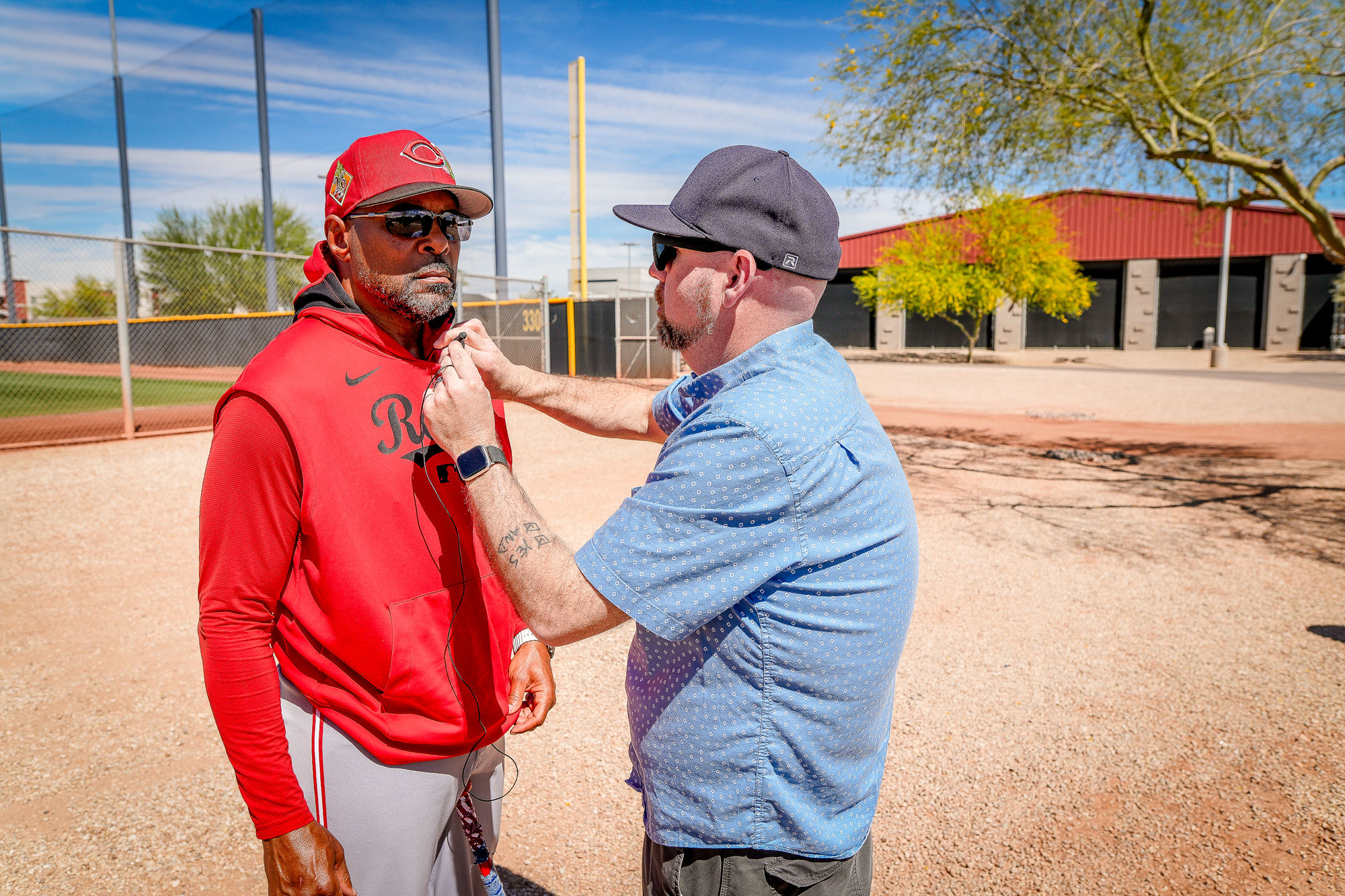 Isaac Stambaugh setting up a mic on a Cincinnati Reds production at spring training